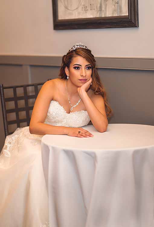Bride sit on the reception table