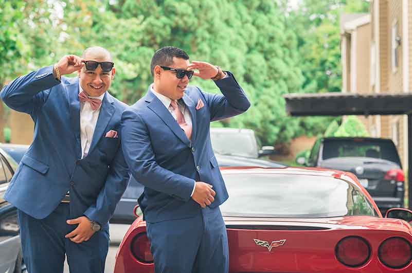 Groom and Best man stand by Ferrari